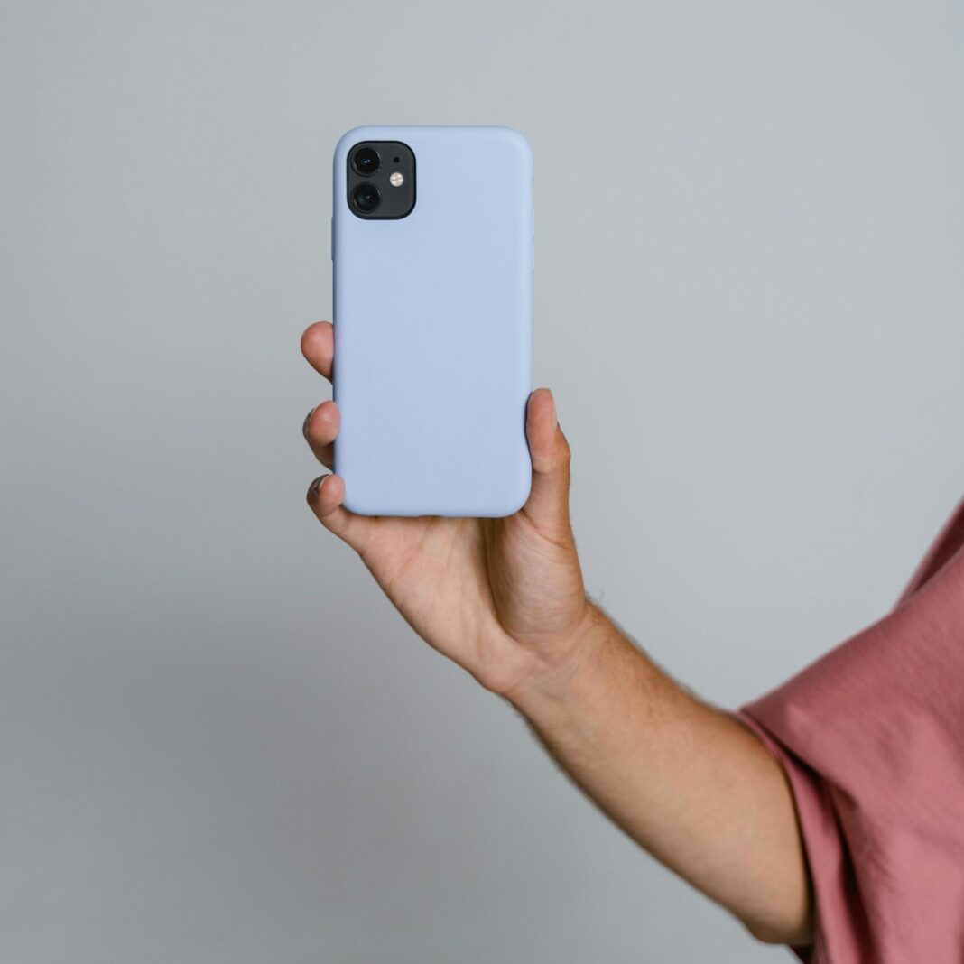 Person Holding White Iphone 5 C